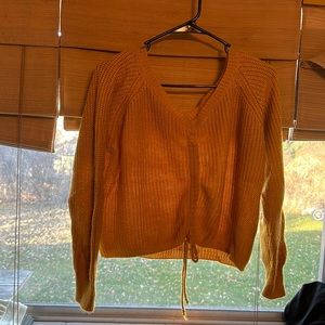 orange tie sweater